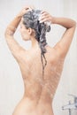 Young woman washing head by shampoo Royalty Free Stock Photo