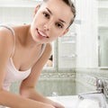 Young woman washing her face with clean water Royalty Free Stock Photo