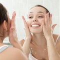 Young woman washing her face with clean water Royalty Free Stock Photo