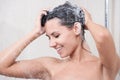 Young woman washing head by shampoo Royalty Free Stock Photo