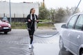Young Woman Washing Herself A Car