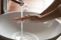 Young woman washing hands over bathroom sink, close up view Royalty Free Stock Photo