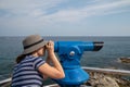 Young woman watching in blue telescope Royalty Free Stock Photo