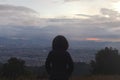 young woman watching bogota cityscape at dusk from a mountain viewpoint Royalty Free Stock Photo