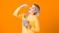 Young woman watching a movie and eating popcorn. Royalty Free Stock Photo