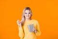 Young woman watching a movie and eating popcorn. Royalty Free Stock Photo