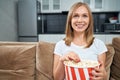 Young woman watching movie and eating popcorn at home Royalty Free Stock Photo