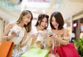 young woman watching smart phone in shopping mall Royalty Free Stock Photo