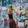 Young woman watching street art in Brick Lane, Shoreditch