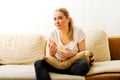 Young woman watching TV and eating chips Royalty Free Stock Photo