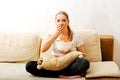 Young woman watching TV and eating chips Royalty Free Stock Photo