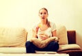 Young woman watching TV and eating chips Royalty Free Stock Photo