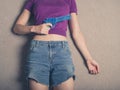 Young woman with water pistol on carpet Royalty Free Stock Photo