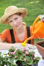 Young woman watering flowers Royalty Free Stock Photo