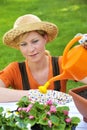 Young woman watering flowers Royalty Free Stock Photo