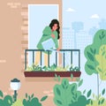 Young woman watering flowers on the balcony Royalty Free Stock Photo