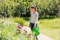 Young woman watering flowers at garden Royalty Free Stock Photo