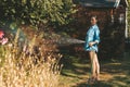 Young woman watering plants with a hose