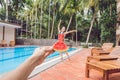 Young woman in a watermelon dress on a pool background. The concept of summer, diet and healthy eating Royalty Free Stock Photo
