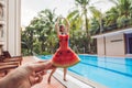 Young woman in a watermelon dress on a pool background. The concept of summer, diet and healthy eating Royalty Free Stock Photo