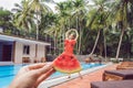 Young woman in a watermelon dress on a pool background. The concept of summer, diet and healthy eating Royalty Free Stock Photo