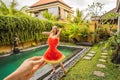 Young woman in a watermelon dress on a pool background. The concept of summer, diet and healthy eating Royalty Free Stock Photo