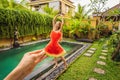 Young woman in a watermelon dress on a pool background. The concept of summer, diet and healthy eating Royalty Free Stock Photo