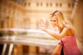 Young woman waves hand