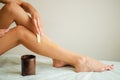 Young woman waxing her lower leg with honey Royalty Free Stock Photo