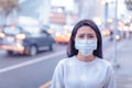 Young woman wear mask in the city during Smog day