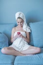 Young Woman Wearing Bath Towel with Red Cell Phone Royalty Free Stock Photo