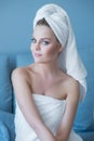 Young Woman Wearing Bath Towel Sitting on Sofa Royalty Free Stock Photo