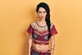 Young woman wearing bindi and bollywood clothing skeptic and nervous, frowning upset because of problem