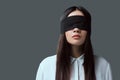 young woman wearing black blindfold