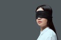 young woman wearing black blindfold