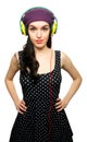 Young Woman wearing Black Polka-Dot dress and Listening to Headphones