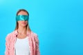 Young woman wearing blindfold. Space for text