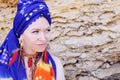 Young woman wearing boho chic scarf on a head and handmade feathers necklace and earrings Royalty Free Stock Photo