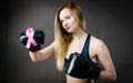 Young woman wearing boxing gloves having pink ribbon Royalty Free Stock Photo