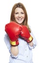 Young woman wearing boxing gloves smiling Royalty Free Stock Photo