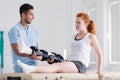 Young woman wearing a brace during rehabilitation with her physiotherapist Royalty Free Stock Photo