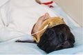 Young woman wearing the brainwave Scanning Headset Sits in a Chair In the Brain Study Laboratory Neurological Research Center