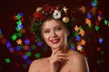 young woman wearing Christmas wreath on blurred background. Bokeh effect Royalty Free Stock Photo