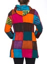 Young woman wearing coat of many colors hooded long patchwork jacket