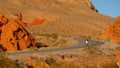 Young woman wearing a cowboy hat walking down a lonesome road in the desert of Arizona Royalty Free Stock Photo