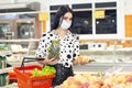 Young woman wearing disposable medical mask shopping in supermarket Royalty Free Stock Photo