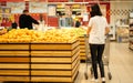 Young woman wearing disposable medical mask shopping in supermarket during coronavirus pneumonia outbreak. Royalty Free Stock Photo