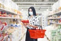 Young woman wearing disposable medical mask shopping in supermarket Royalty Free Stock Photo