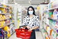 Young woman wearing disposable medical mask shopping in supermarket Royalty Free Stock Photo