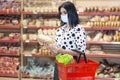 Young woman wearing disposable medical mask shopping in supermarket Royalty Free Stock Photo